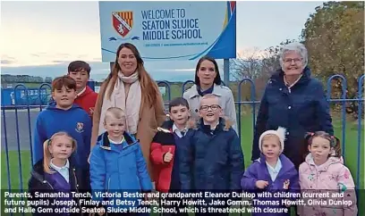 ?? ?? Parents, Samantha Tench, Victoria Bester and grandparen­t Eleanor Dunlop with children (current and future pupils) Joseph, Finlay and Betsy Tench, Harry Howitt, Jake Gomm, Thomas Howitt, Olivia Dunlop and Halle Gom outside Seaton Sluice Middle School, which is threatened with closure