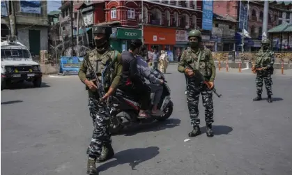  ?? Photograph: Mukhtar Khan/AP ?? Indian paramilita­ry soldiers patrol in Srinagar, Indian-controlled Kashmir. Kashmiri Pandits have been demanding more security in light of the violence.