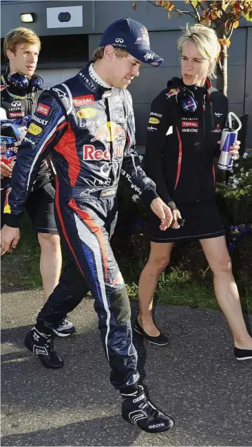  ??  ?? Time out: Red Bull’s Sebastian Vettel chatting with a female team member. — AP