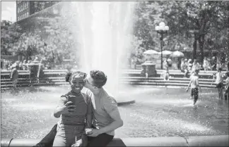  ?? TODD HEISLER / THE NEW YORK TIMES ?? A couple take a selfie on a warm afternoon in Washington Square Park in New York. In recent weeks, Instagram has been cracking down on businesses that turn their clients’ accounts into comment bots as part of a rogue marketing tactic.