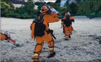  ??  ?? A Cal Fire hand crew from the Department of Correction­s heads toward the fire.