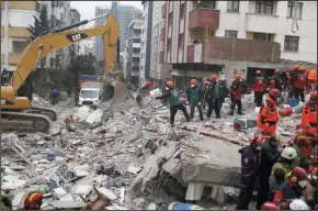  ?? CAN OZER/DEPO PHOTOS/ZUMA PRESS ?? Rescue workers form a line to remove rubble from an eight-story building which collapsed in Istanbul on Wednesday. The building had 43 residents living in 14 apartments.