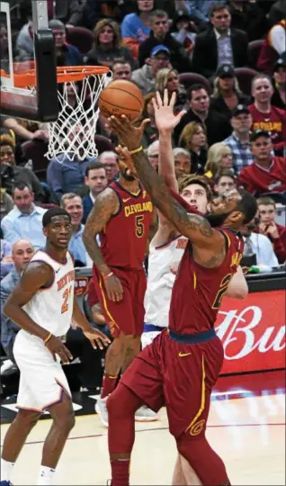  ?? PATRICK HOPKINS — THE NEWS-HERALD ?? LeBron James drives to the basket against the Knicks on Apri 11 at Quicken Loans Arena.