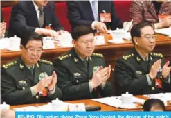  ?? — AFP ?? BEIJING: File picture shows Zhang Yang (center), the director of the state’s Central Military Commission’s political department, applauds China’s Premier Li Keqiang’s speech during the opening session of the National People’s Congress in Beijing.