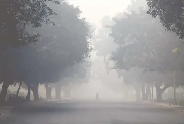  ?? REUTERS ?? A man crosses a road on a smoggy morning in New Delhi on Thursday.