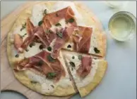  ?? SARAH CROWDER, THE ASSOCIATED PRESS ?? A burrata and prosciutto pizza: the perfect combinatio­n of creamy cheese, and sweet and salty meat.