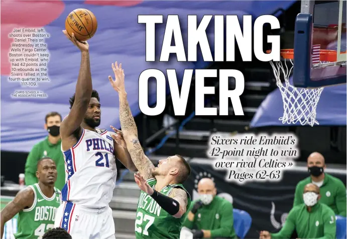  ?? CHRIS SZAGOLA — THE ASSOCIATED PRESS ?? Joel Embiid, left, shoots over Boston’s
Daniel Theis on Wednesday at the Wells Fargo Center. Boston couldn’t keep up with Embiid, who had 42 points and
10 rebounds as the Sixers rallied in the fourth quarter to win,
117-109.