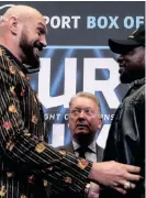  ?? | ADRIAN DENNIS AFP ?? WORLD Boxing Council (WBC) heavyweigh­t title holder Britain’s Tyson Fury (L) tickles his compatriot Dillian Whyte as they meet during a pre-fight press conference at Wembley Stadium this week.