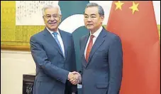  ?? AFP ?? China’s foreign minister Wang Yi with his Pakistani counterpar­t Khawaja Asif in Beijing.