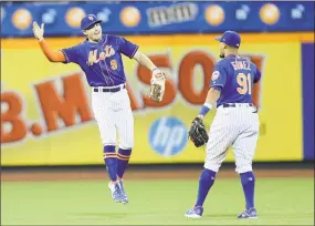  ?? Elsa / Getty Images ?? Brandon Nimmo, left, and Carlos Gomez of the Mets celebrate their win over the Nationals Monday night at Citi Field in New York.