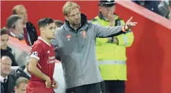  ?? — AFP ?? Liverpool’s German manager Jurgen Klopp (C) speaks to Liverpool’s Brazilian midfielder Philippe Coutinho as he prepares to play during the Uefa Champions League Group E match between Liverpool and Sevilla at Anfield in Liverpool.