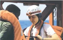  ?? AP ?? An MSF worker helps a rescued man take off his life-jacket as he arrives on board the Ocean Viking rescue ship after being saved from a rubber boat in distress off Libya.