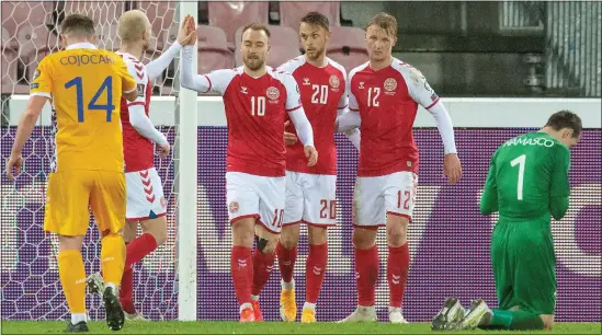  ??  ?? Denmark celebrate during their commanding display against Moldova last night... a warning for Scotland