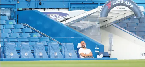  ?? AP ?? Manchester City head coach Pep Guardiola sits on the bench ahead of their English Premier League match against Chelsea at Stamford Bridge, in London, England, on Thursday.