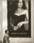  ?? AP PHOTO ?? ▪ A woman walks past a Nirav Modi boutique in Mumbai, February 15.