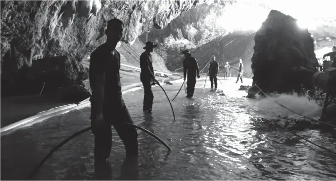  ?? (AP) ?? THAILAND. In this undated file photo provided by Royal Thai Navy on July 7, 2018, Thai rescue teams arrange a water pumping system at the entrance to a flooded cave complex where 12 boys and their soccer coach have been trapped since June 23, in Mae...