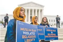  ?? AP PHOTO BY ANDREW HARNIK ?? Zainab Chaudry, Zainab Arain and Megan Fair, from left, with the Council on American-Islamic Relations, stand outside of the Supreme Court on Wednesday for an anti-Muslim ban rally as the court hears arguments about whether President Donald Trump’s ban...