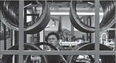 ?? WU CHANGQING / FOR CHINA DAILY ?? A worker checks tires at a production line in Hefei, Anhui province. Global tiremakers eye further on China as the market begins to recover.