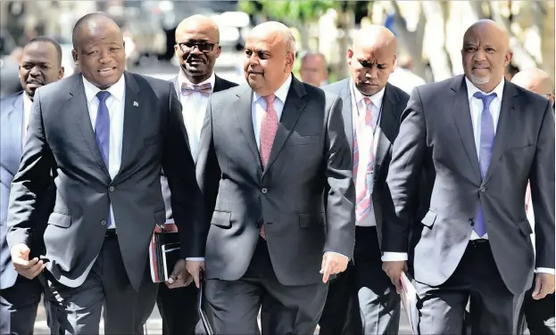  ?? PHOTO: GCIS ?? Finance Minister Pravin Gordhan, his deputy Mcebesi Jonas, far right, and National Treasury director-general Lungisa Fuzile, left, on their way to Parliament to deliver the medium-term budget policy statement.