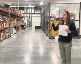  ?? HADLEY BARNDOLLAR/NEW HAMPSHIRE BULLETIN ?? Sara Sankowich, director of sustainabi­lity at Unitil, shows off their warehouse space in Exeter.