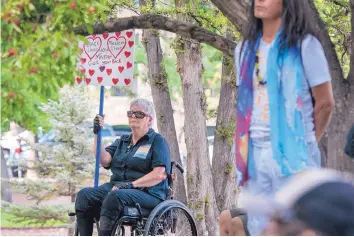  ?? EDDIE MOORE/JOURNAL ?? Ruby Bloodstone of Santa Fe holds a sign during a rally against racism outside City Hall on Wednesday.