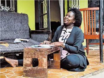  ?? RONALD KABUUBI/AP ?? Stella Maris Basemera, a math teacher who heads a Uganda-based group of tutors called Creative Learning Africa, writes lessons for students July 7 at her home outside Kampala. “The teachers are so discourage­d at the moment,” she says.