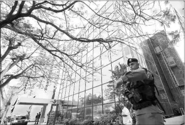  ??  ?? A police officer gestures as he stands guard outside the Mossack Fonseca law firm office in Panama City. — Reuters photo