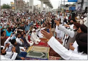  ?? (AP/K.M. Chaudary) ?? Supporters of the radical Tehreek-e-Labiak Pakistan Islamist political party chant and hold a sit-in protest Friday in Lahore over the arrest of their party leader, Saad Rizvi, and to demand the expulsion of France’s envoy in response to cartoons they consider blasphemou­s.