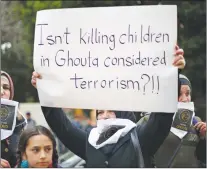  ?? AP PHOTO ?? A Lebanese woman holds a placard during a protest in solidarity with residents of the Syrian capital’s eastern suburb of Ghouta, in front the Russian embassy in Beirut, Lebanon, Sunday.