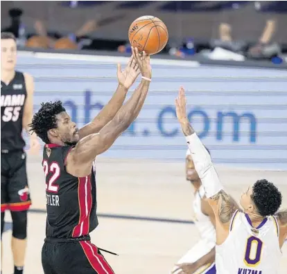  ?? MARK J. TERRILL/AP ?? Jimmy Butler shoots against Lakers' Kyle Kuzma during the second half in Game 3 of basketball's NBA Finals on Sunday in Lake Buena Vista.