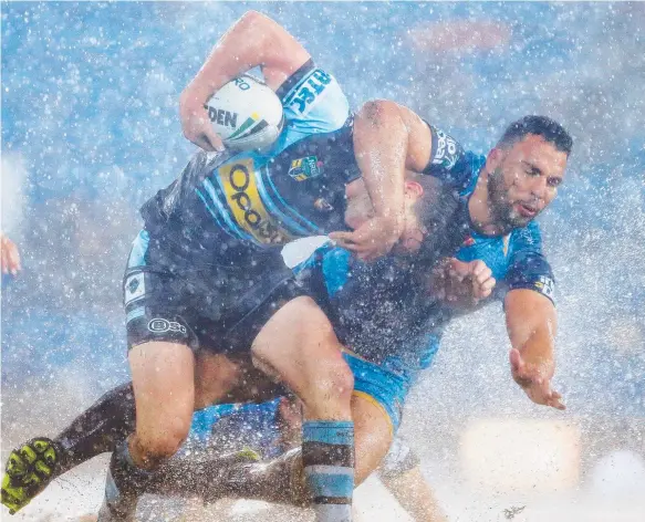  ?? Picture: GETTY IMAGES ?? Sharks playmaker Chad Townsend is hunted down by Titans prop Ryan James, who is hoping to spearhead a belated finals run.