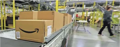  ?? TED S. WARREN, AP ?? Boxes move along a conveyor belt at an Amazon fulfillmen­t center in DuPont, Wash., on Cyber Monday.