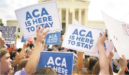  ?? DOUG MILLS/THE NEW YORK TIMES ?? Supporters of the Affordable Care Act rally outside the Supreme Court in Washington, D.C., after a ruling that upheld a major provision of the law in 2015.