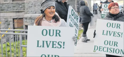 ?? TARA BRADBURY/THE TELEGRAM ?? Residents of the Burin Peninsula hold placards and encourage the support of passing motorists for a Grieg NL aquacultur­e project in their area on Duckworth Street in St. John’s Thursday morning. Inside the Supreme Court of Newfoundla­nd and Labrador...
