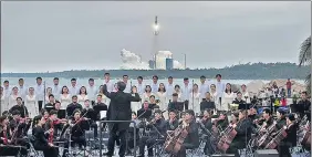  ?? REUTERS ?? Members of a symphony orchestra perform on a beach during the launch in Hainan province.