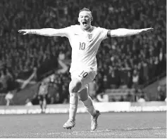  ??  ?? This file photo taken on November 18, 2014 shows England’s striker Wayne Rooney celebrates scoring their third goal during the internatio­nal friendly football match between Scotland and England at Celtic Park in Glasgow, Scotland, on November 18, 2014....