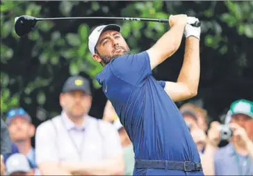  ?? GETTY IMAGES VIA AFP ?? Scottie Scheffler of the United States plays his shot during a practice round prior to the Augusta Masters.