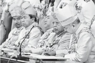  ??  ?? Sultan Nazrin (right) signing the instrument of office as Timbalan Yang di-Pertuan Agong at the 244th (Special) Meeting of the Conference of Rulers in Kuala Lumpur yesterday.