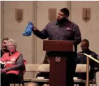  ?? MIKE DE SISTI / MILWAUKEE JOURNAL SENTINEL ?? Molson Coors employee Byron Johnson holds up a pair of work gloves that he wore the day of the shooting.