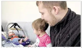  ?? MIKE HOUSEHOLDE­R / AP ?? Luke Waid, with his daughter, Sophia, 2, and son, Luke Jr., seeks unspecifie­d damages from Michigan Gov. Rick Snyder, Michigan and the city of Flint, claiming Sophia has been sickened by the city’s water in a federal lawsuit filed Monday.