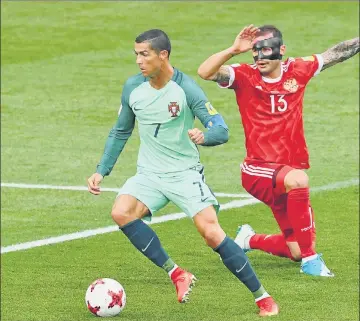  ?? AFP PHOTO ?? Cristiano Ronaldo (left) scored Portugal’s lone goal against Russia in the eighth minute on Wednesday.