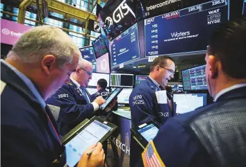  ?? Bloomberg ?? Traders at the New York Stock Exchange. US stocks started the week lower, while Asian equities slumped as investors grappled with US threats to expand tariffs on Chinese goods.
