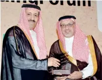  ??  ?? Prince Husam bin Saud bin Abdulaziz presents trophy to CPC Director of Business Developmen­t and head of CSR Department Faysal Alaquil.