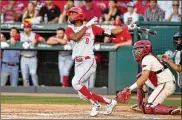  ?? MICHAEL WOODS / ASSOCIATED PRESS ?? North Carolina State’s Jose Torres hits a home run against Arkansas in a super regional game Sunday. Home runs have defined the NCAA baseball tournament so far with 381 hit in 123 games,