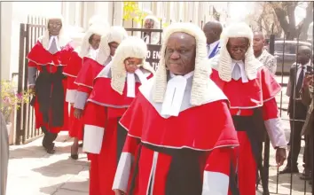  ??  ?? A procession of judges at the official opening of Parliament in Harare last week. The wearing of colonial robes and wigs by African judges has been a subject of intense debate