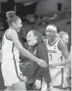  ?? MANDATO/GETTY CARMEN ?? The UConn bench celebrates late in Saturday’s victory over Iowa in the Sweet 16 in San Antonio.