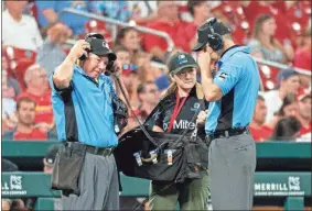  ?? AP-L.G. Patterson, File ?? In this 2019 file photo, umpires use headsets during a video review of a call during the seventh inning of a baseball game between the St. Louis Cardinals and the Miami Marlins in St. Louis. Taking a chance to review instant replay, Major League Baseball doubled the isolated cameras available for video reviews to 24 this year.