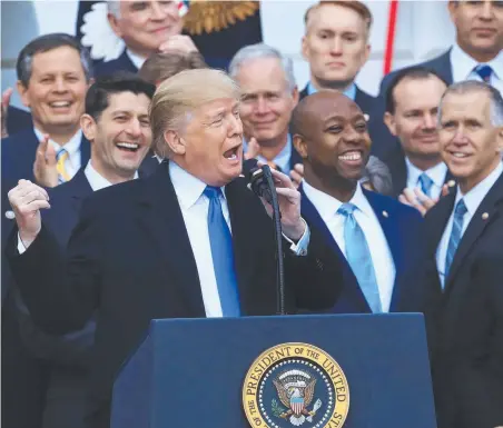  ?? Picture: AP ?? US President Donald Trump speaks about the passage of the tax overhaul bill on the South Lawn at the White House in Washington, with his jubilant Republican party members.