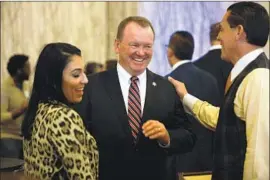  ?? Gary Coronado Los Angeles Times ?? SHERIFF Jim McDonnell, center, talks with Alexandra Kazarian and Felipe Plascencia on election night in L.A. He’s trailing Villanueva by 58,000 votes.