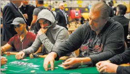  ?? Bridget Bennett ?? Las Vegas Review-journal @bridgetkbe­nnett Dieter Dechant, second from right, a relief-shift supervisor at the Green Valley Ranch poker room, collects his chips during the World Series of Poker Wednesday at the Rio.